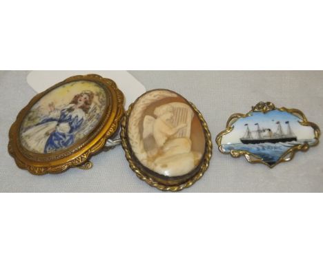 An enamel brooch depicting SS Africa, a cameo brooch and a further brooch depicting Lorna Doone
