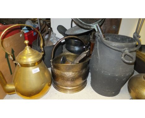A collection of metalwares to include an Eastern style brass jug with swing handle, cast iron cauldron, three coal scuttles, 
