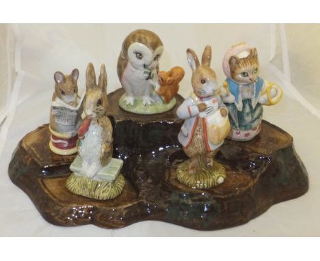 A Beswick tree trunk stand and five various figures including "Fierce Bad Rabbit" (1977), "Peter with Post Bag" (1996), "Old 
