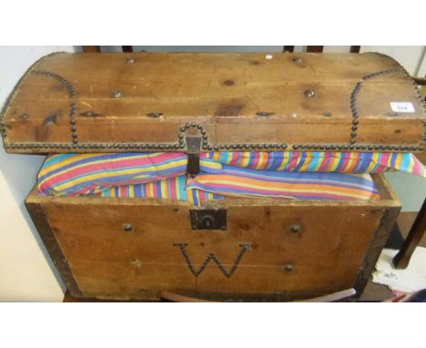A Victorian brass studded pine dome top trunk and quantity of cushions