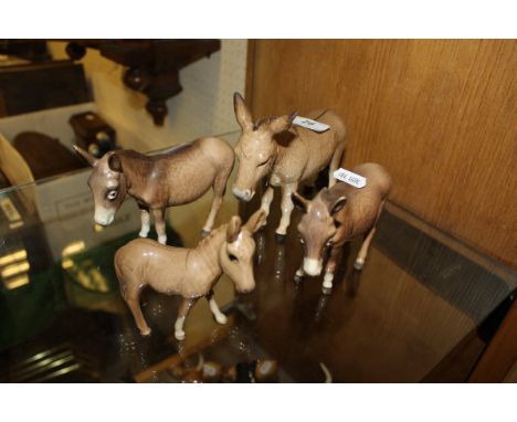 A selection of four Beswick donkey and foal figures CONDITION REPORTS All have some light wear and dirt, and some crazing to 
