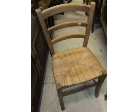 A set of six modern beech framed rush seat ladder back kitchen chairs