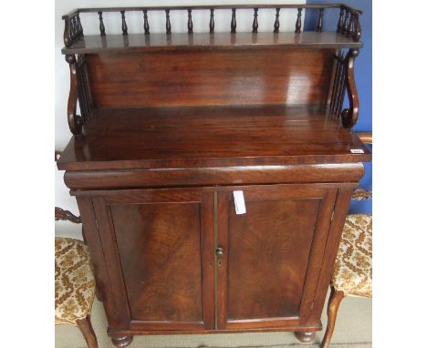 A late Regency mahogany chiffonier, the galleried top above a shelved superstructure on S scroll supports above cushioned dra