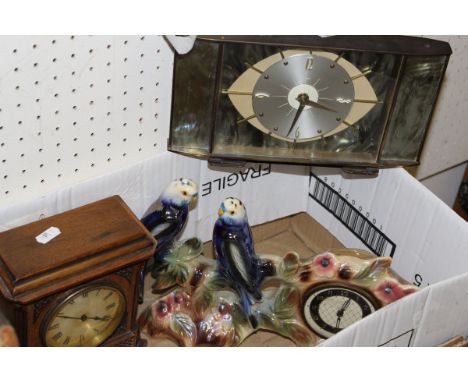 A box containing a Metamec mantel clock, a mahogany cased mantel clock, an oak cased aneroid barometer, duck car mascot and a