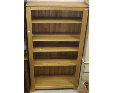 A modern oak five shelf open bookcase
