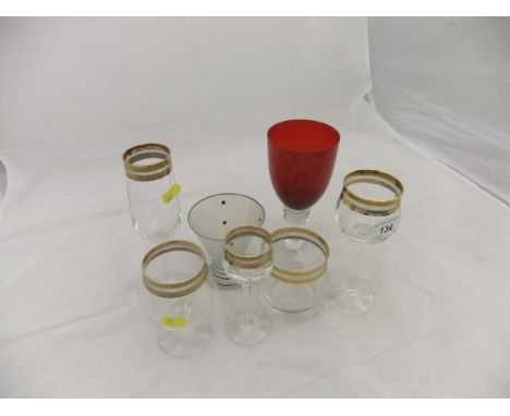 A large collection of drinking glasses with gilt decorated rims to include brandy balloons, wines, tumblers, liqueur glasses 