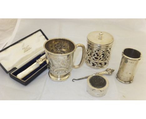 A Victorian silver small mug with embossed floral decoration, an Edwardian silver pierced jar and cover, silver trinket dish 