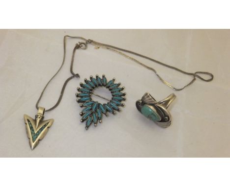 A native American, possibly Navaho, silver and turquoise ring, together with a pendant necklace in the form of an arrow head,