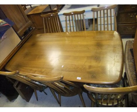 A modern Ercol dining table and six stickback chairs