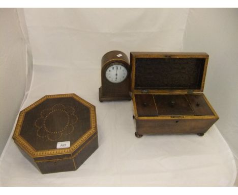 A 19th Century mahogany sarcophagus shaped tea caddy, the hinged lid opening to reveal three lidded compartments, a 19th Cent