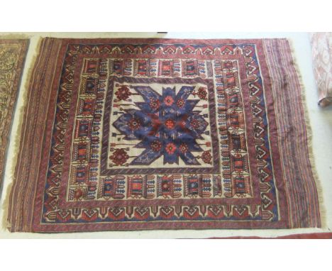 A Shiraz tribal carpet, the Kelim style oatmeal ground decorated with stylised architectural medallions in pale red, burgundy