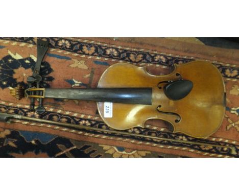 A full size violin with scrolled head stock, ebony effect finger board  CONDITION REPORTS Violin has a one piece back, overal