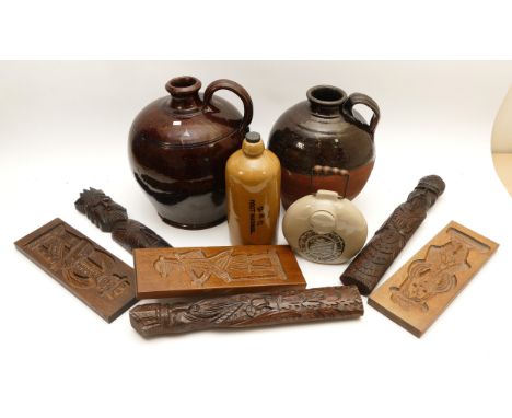 Two stoneware flagons, together with a Boots ceramic hot water bottle and a D.B.C foot warmer, and several wooden carvings, t