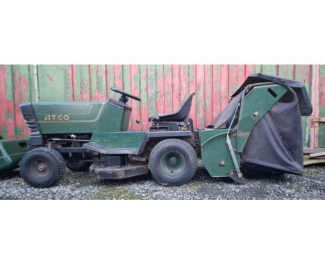 An Atco ride-on tractor with powered lawn sweeper, model 12/36, series No. L80188, rotary cut with Briggs & Stratton engine, 