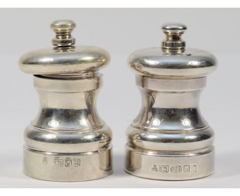 A silver pepper grinder, London 1994, together with another silver pepper grinder, London 2002, 7cm tall (2)