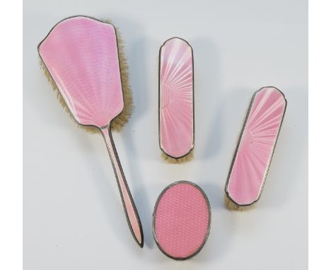 A silver and pink guilloche enamel dressing table Hair brush, Birmingham 1935, two rectangular clothes brushes, Birmingham 19