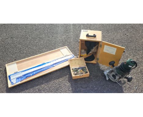 A boxed Bosch POF 500A router, a boxed APTC router bit set, a boxed micrometer 75cm in length, also a boxed binocular microsc
