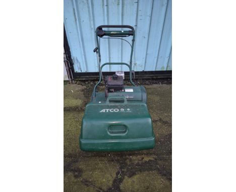 An Atco Balmoral 20SK cylinder lawn mower, having petrol driven Kawasaki engine, with scarifier attachment and associated pap