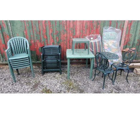 A group of garden furniture pieces, to include a table, set of six chairs, a pair of folding recliner chairs with cushions, a