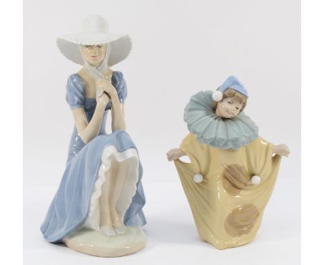 Two Lladro Nao figurines, to include, a pensive lady in a sunhat, perched on a rock, 28cm, and a clown, in a beige outfit, co