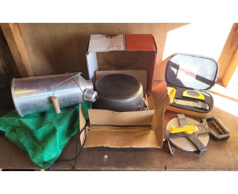 A boxed Strait-Line stud finder, a 50m hand held tape measure, a Wagner Dutch oven casserole dish, also a Ghillie kettle.