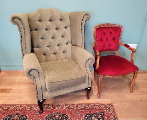 An early 20th century high wingback armchair, button back with drop-in cushion seat, professionally reupholstered in a green 