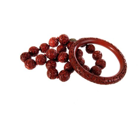 A Chinese lacquer bead necklace, each bead having flower and swirl design, together with matching bangle (2)