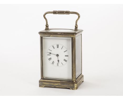 A brass carriage timepiece, the traditional rectangular glazed case with white enamel dial having Roman numerals, AF