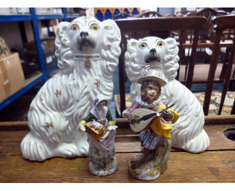 Two Staffordshire ceramic dogs, together with a selection of five ceramic figures, a male and a female carrying chicken cages