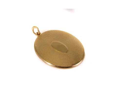A 15ct gold locket, having engine turned design to front and back, approx 10g