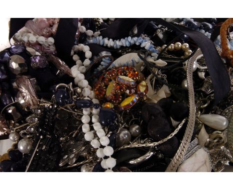 A collection of costume jewels, comprising yellow metal chains, a gem set bangle, a butterfly bracelet, a black taxi brooch a