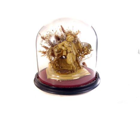 An Eichwald pipe rack in glass domed case, the figure of a man feeding a horse in yellow glaze and heightened in gilt