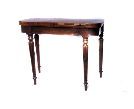 A William IV rosewood fold over card table, opens to reveal dark green felted playing surface, supported on lappet carved leg