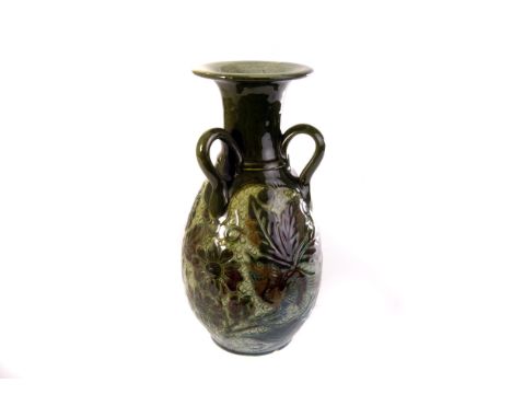 A Lauder Barum Art Pottery vase, the green and brown glazed vase, with bird amongst foliage decoration, having three handled 