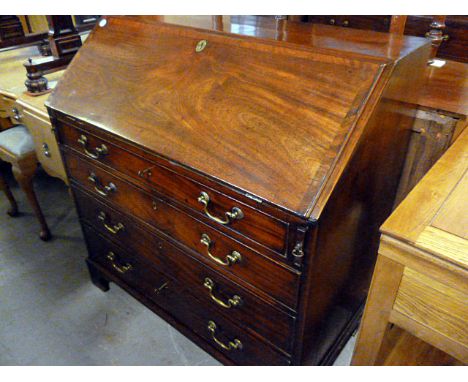 A George III mahogany cross banded bureau, fold out front with fitted interior on bracket feet, approx 101cm W