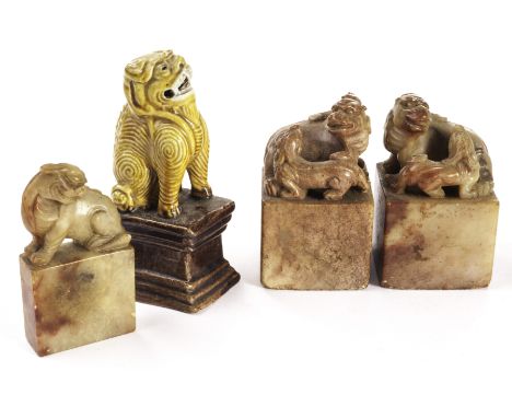 A small collection of Fo dogs, comprising a pair of soapstone scholars scroll weights with large and small dog on each, a pal