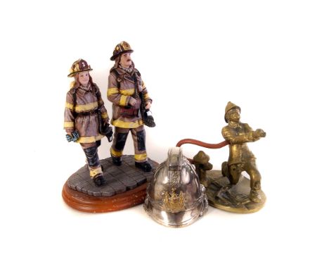 A selection of white metal, brass and resin fire fighter related figures, including a helmet inkwell, a helmet paperweight, t