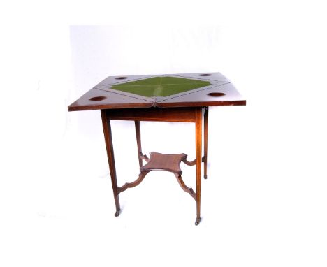 An Edwardian mahogany envelope card table, opens to reveal green felt playing surface with four counter bowls, above a single