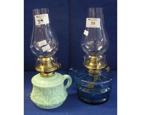 Two similar single oil burner chamber stick lamps, one blue glass, the other green slag type glass. (2)(B.P. 24% incl. VAT)