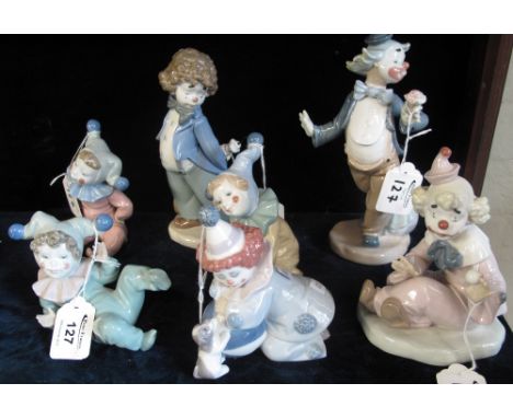 Seven similar Spanish porcelain mainly Nao but also one Lladro porcelain study of children and clowns. (7)(B.P. 24% incl. VAT