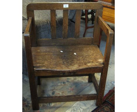 20th Century oak stick back type open armchair.(B.P. 24% incl. VAT)