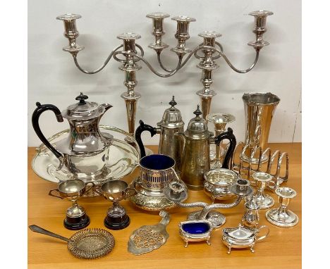 A large volume of silver plated items including a pair of substantial three light candlesticks