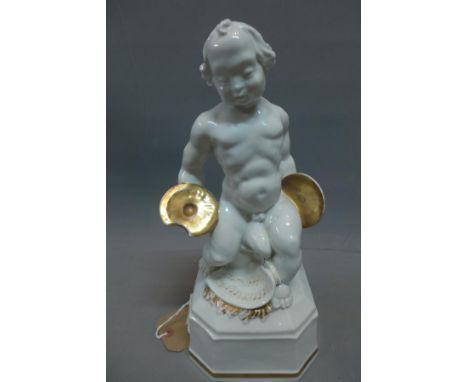 A German Lorenz Hutschenreuther, Selb, porcelain figure of a young child playing the cymbals, parcel gilded, marked to base, 