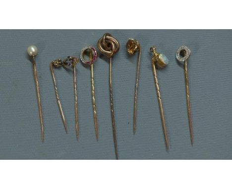 A collection of eight gold tie pins, to include an 18ct yellow gold and diamond tie pin, a gold, seed pearl and diamond set t