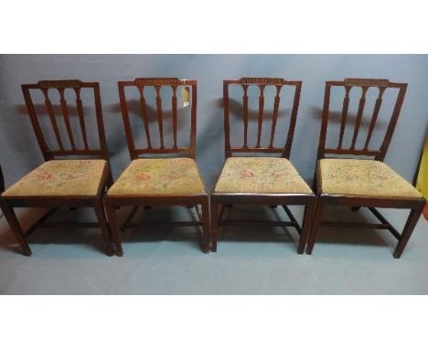 A set of four 19th century mahogany dining chairs with tapestry upholstered drop in seats. 