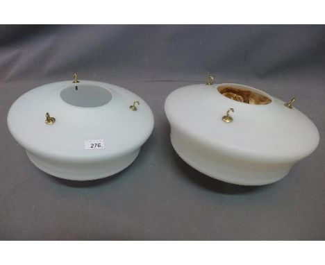 A pair of opaque glass ceiling light shades. 