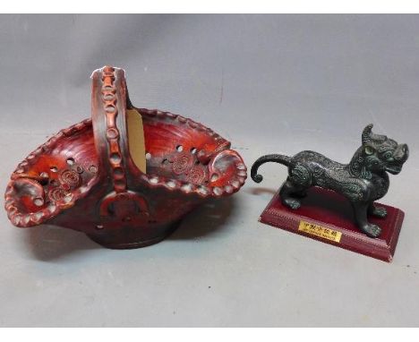 A Chinese bronze mythical dog together with a Chinese ceramic basket. 
