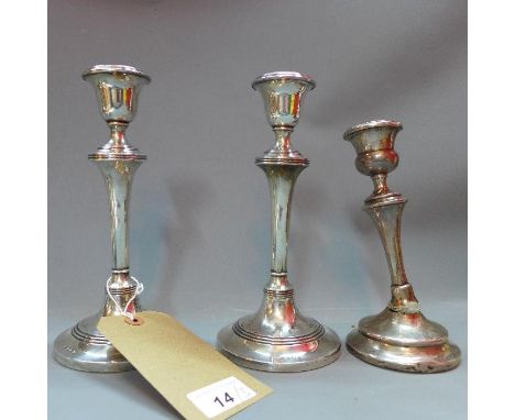 A pair of filled silver candlesticks, Birmingham 1911, makers mark L&S, together with a filled silver candlestick, indistinct