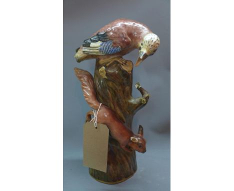 A large 19th/20th century Meissen porcelain group of a bird and squirrel on a tree trunk. (a/f) 