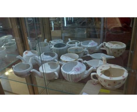 A collection of eight porcelain feeding cups, of various sizes and forms, (16) 